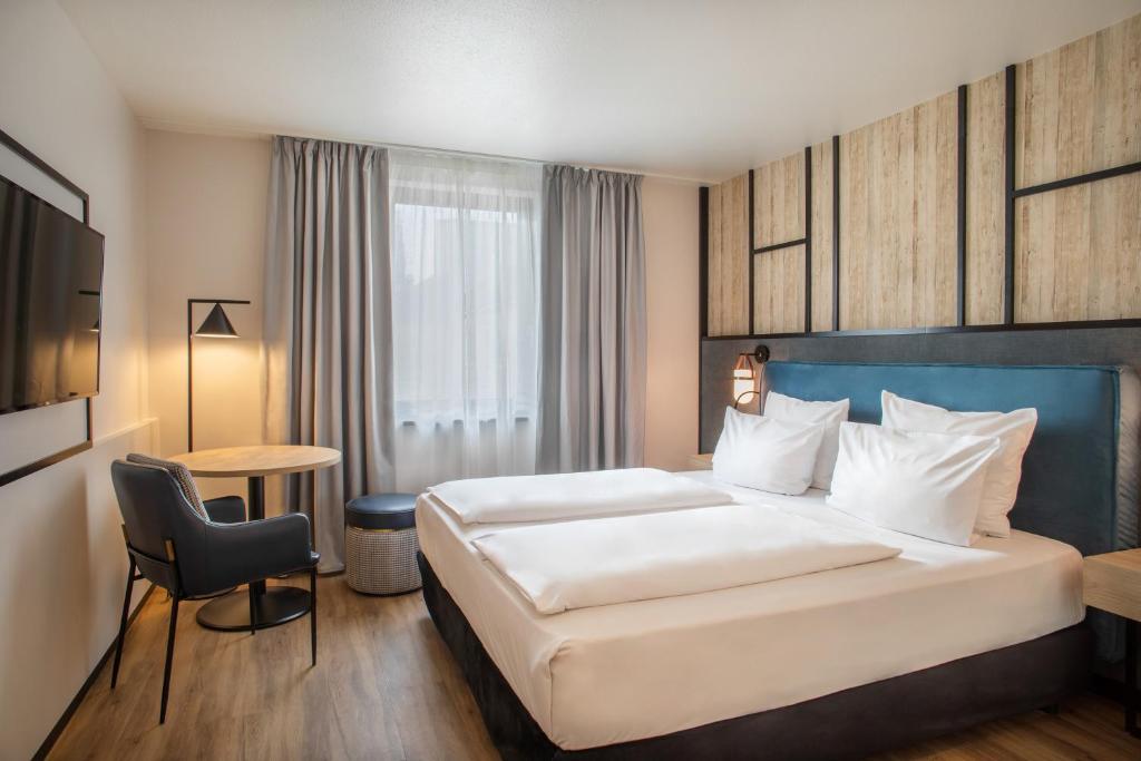 מיטה או מיטות בחדר ב-Hotel München City Center affiliated by Meliá