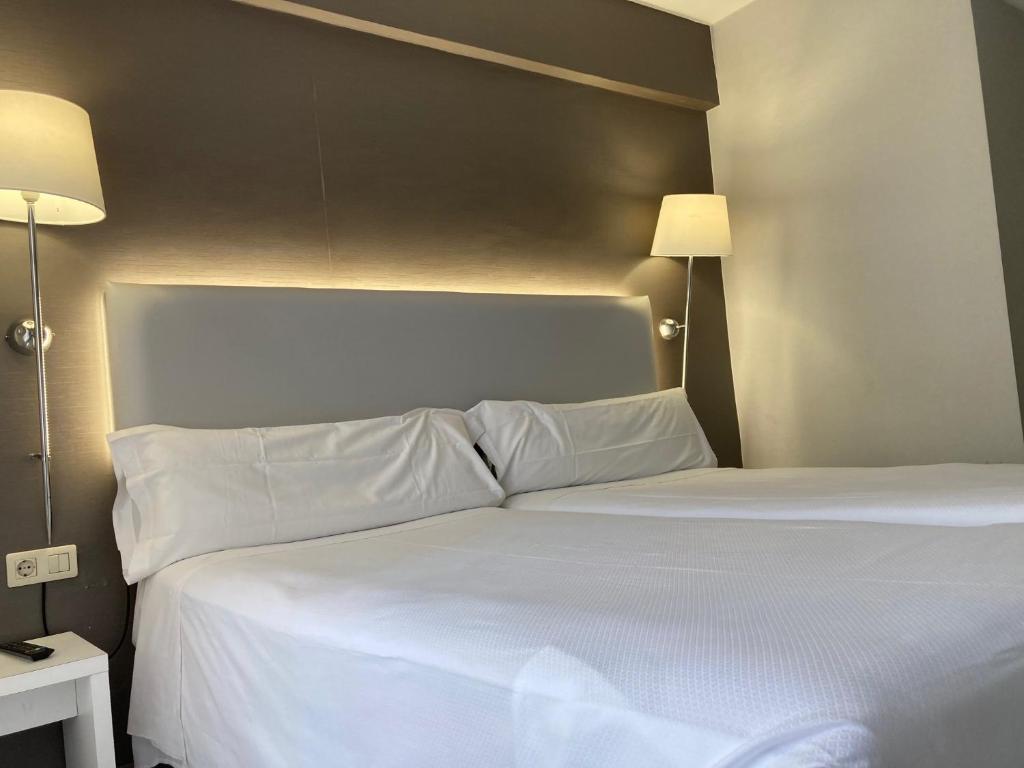Postel nebo postele na pokoji v ubytování Hotel Bilbi