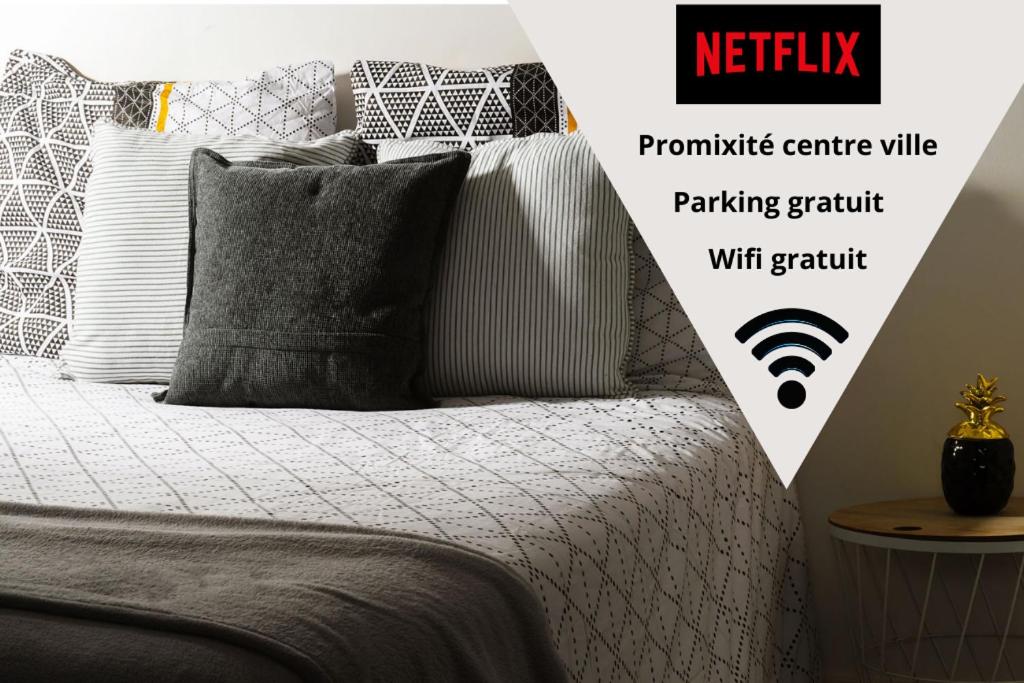 a bedroom with a bed with a wifi sign on it at LD-Location Montluçon Intermarché in Montluçon