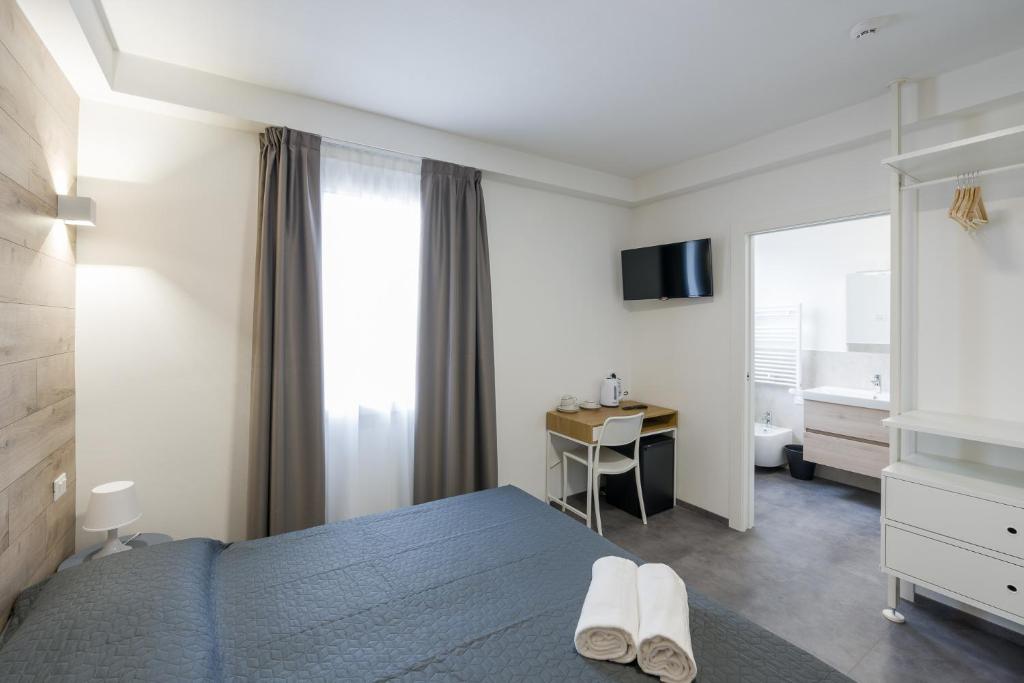 a bedroom with a bed and a desk and a television at Boutique Hotel Nuovo Cason in Cavallino-Treporti