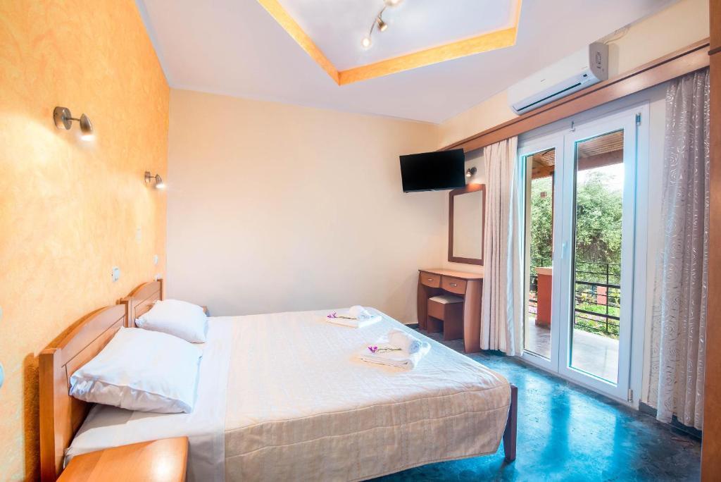 A bed or beds in a room at Bozikis Apartments