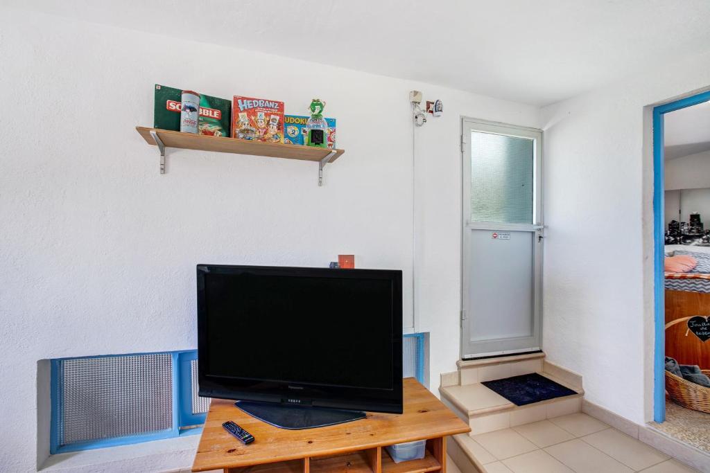 Televízia a/alebo spoločenská miestnosť v ubytovaní Casa Bene