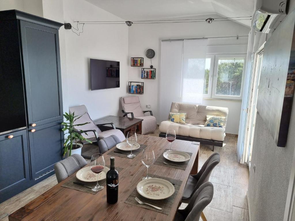 a living room with a table and chairs at Aksa Residences in Vir