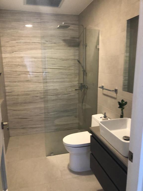 a bathroom with a shower and a toilet and a sink at Luxury condo in cap cana in Punta Cana