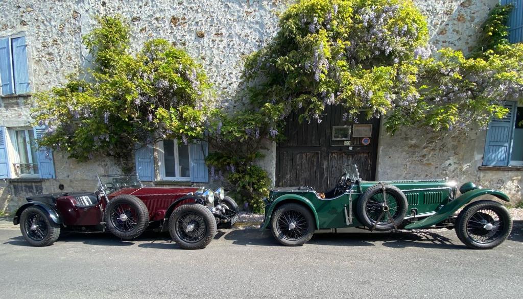 two old cars parked in front of a building at BedandBeige, La Belle Etape in Linas