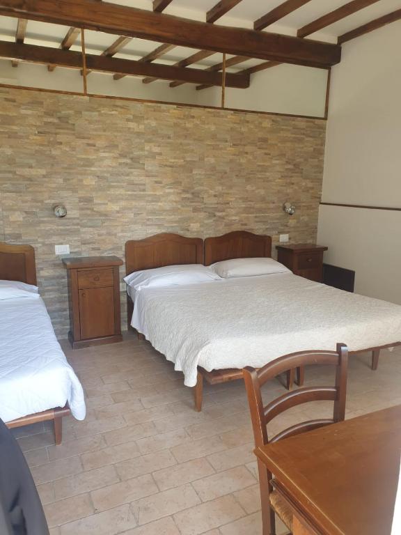 Postel nebo postele na pokoji v ubytování Agriturismo Le Querce