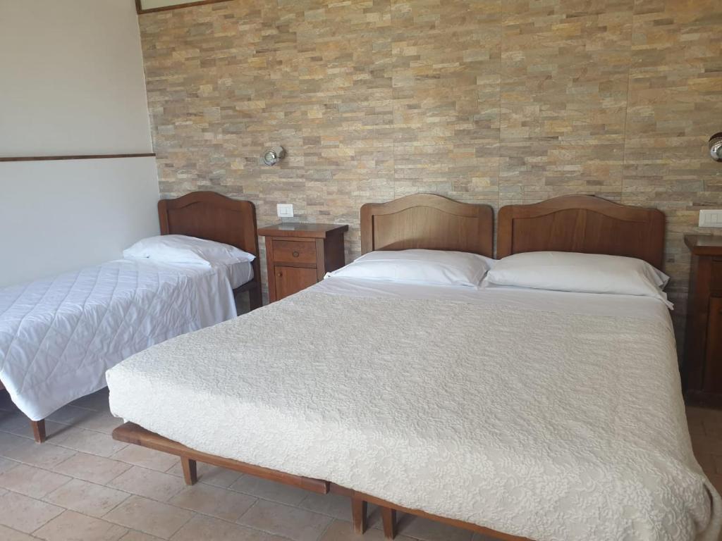 Postel nebo postele na pokoji v ubytování Agriturismo Le Querce
