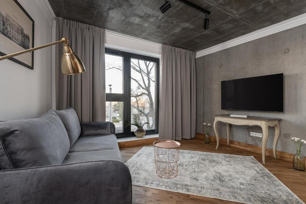 Televízia a/alebo spoločenská miestnosť v ubytovaní Apartamenty Przystanek Przy Klifie