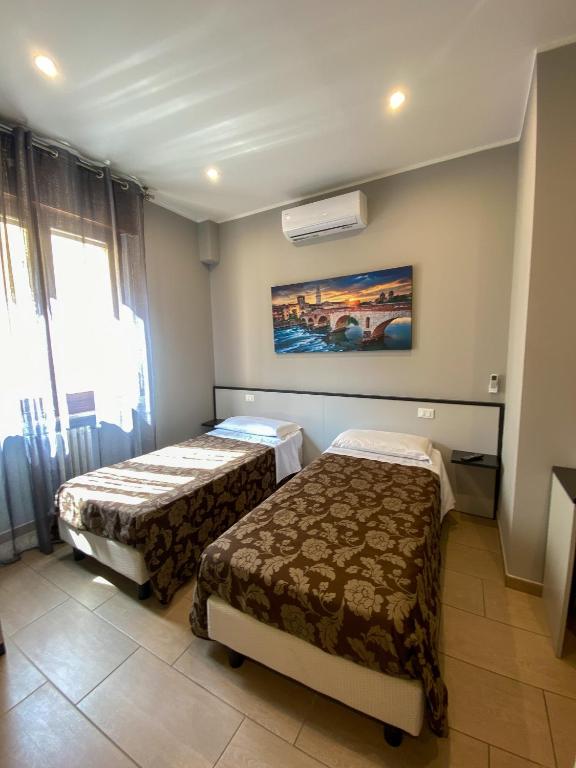 Postel nebo postele na pokoji v ubytování Hotel Arena