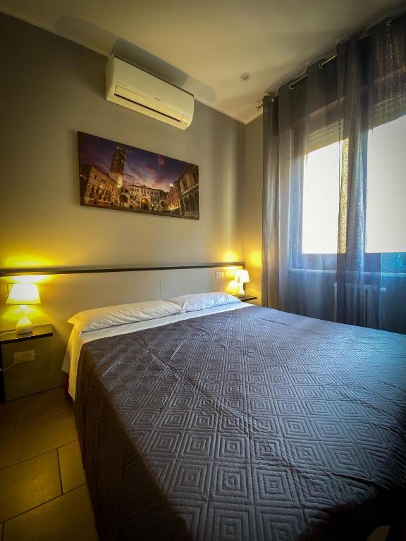 Postel nebo postele na pokoji v ubytování Hotel Arena