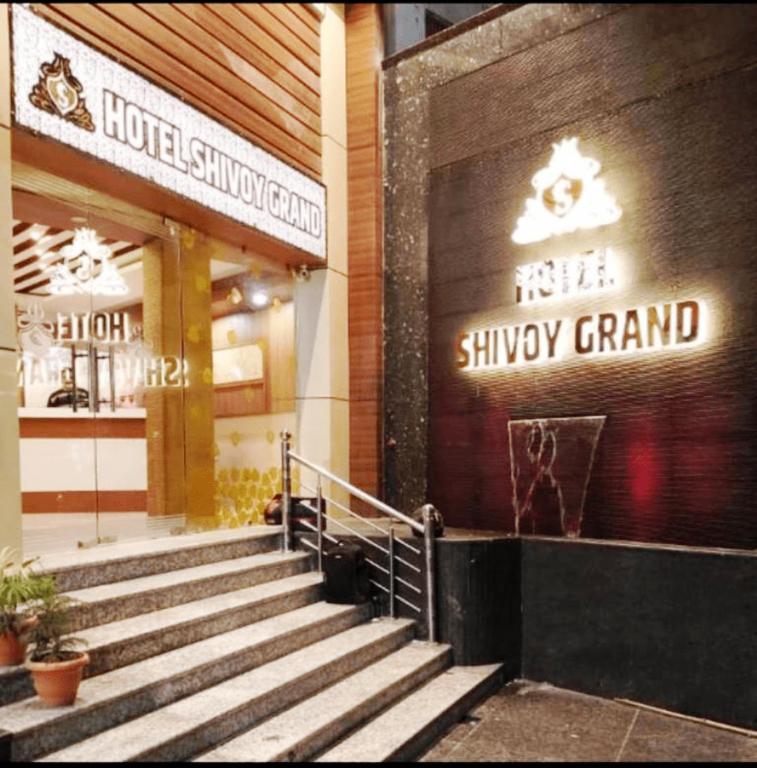 a building with stairs in front of a shopping center at HOTEL SHIVOY GRAND in Varanasi