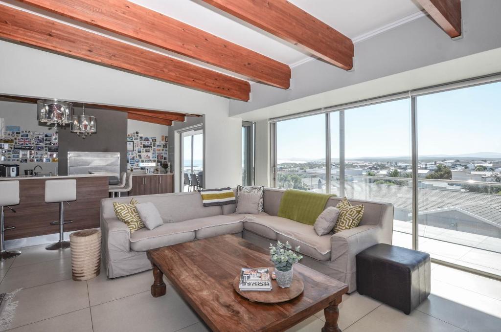 a living room with a couch and a table at 21 Flamingo House in Yzerfontein