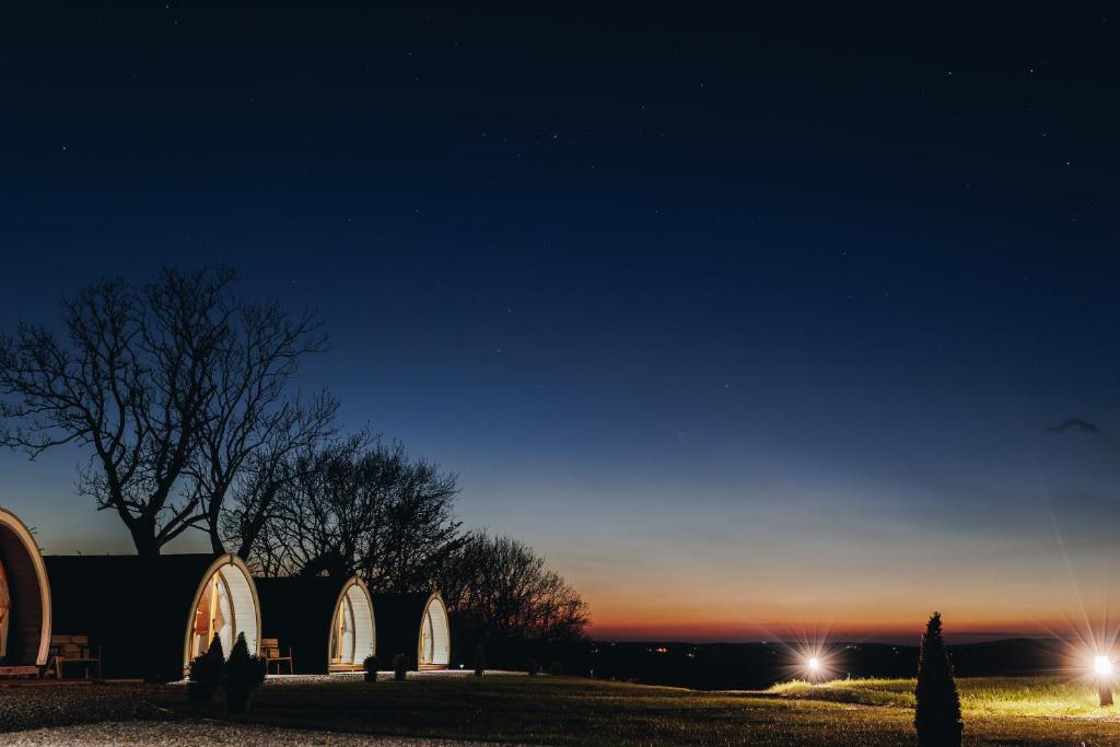 a group of domed buildings in a field at night at North Coast 9 Glamping in Cape Castle