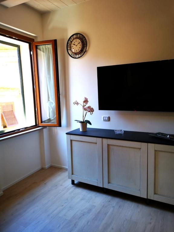 a living room with a flat screen tv on the wall at Casa vacanza il Campanile in Alghero