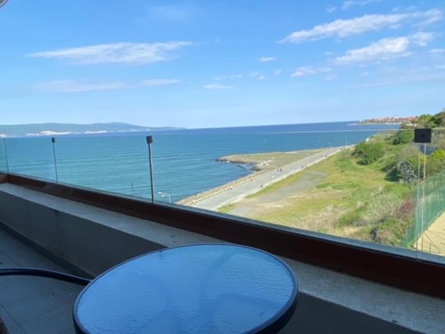 a table in a room with a view of the ocean at PARADISO 'B' 605 Private Apartment Nessebar in Nesebar