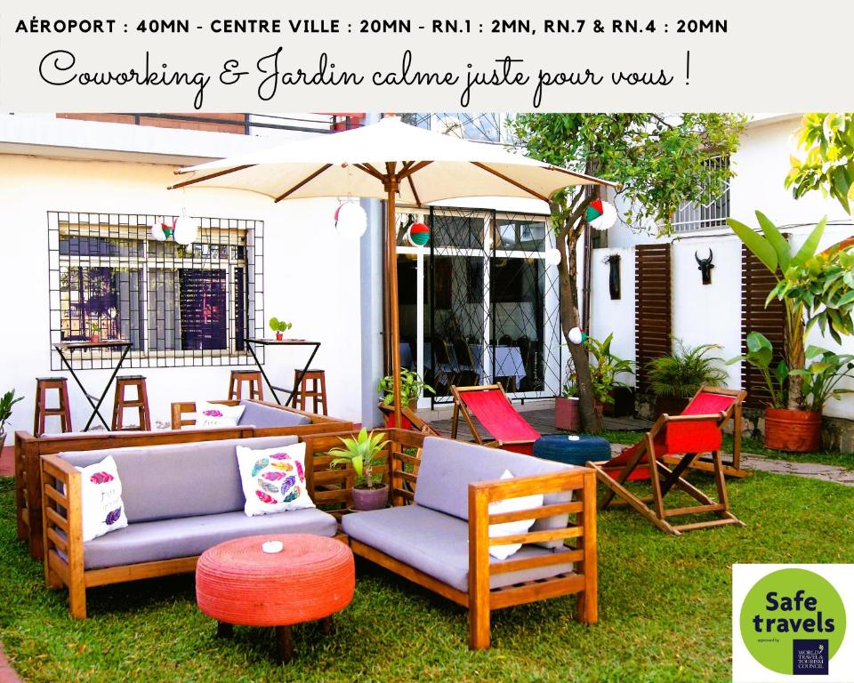 a patio with two couches and an umbrella and chairs at Villa Mahefa - WIFI - Canal Plus - Terrasse & Jardin in Antananarivo