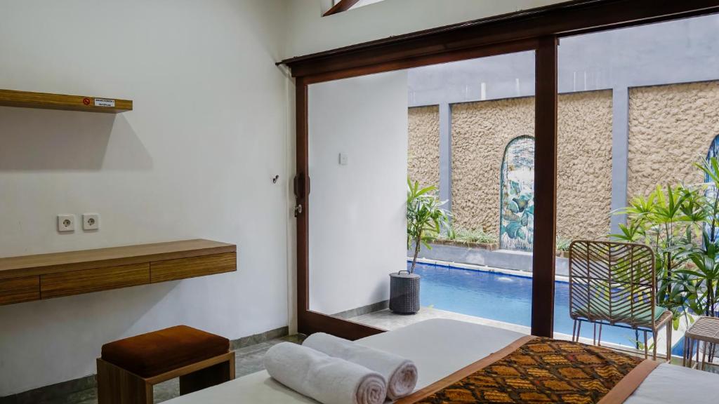 Postel nebo postele na pokoji v ubytování Pondok Pekak Guesthouse