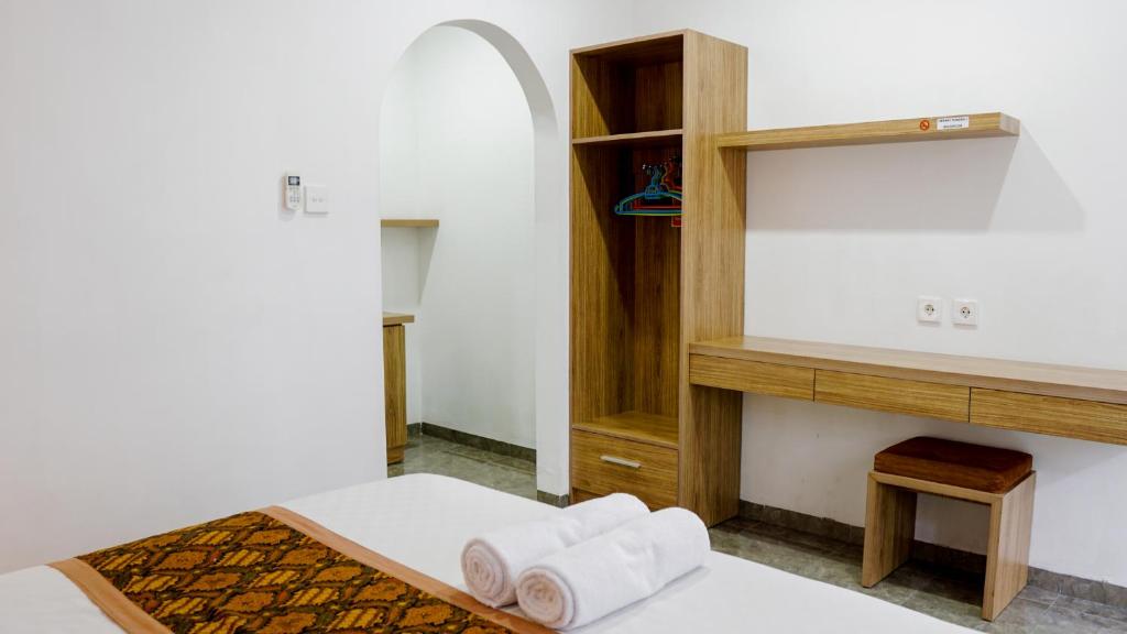 Postel nebo postele na pokoji v ubytování Pondok Pekak Guesthouse