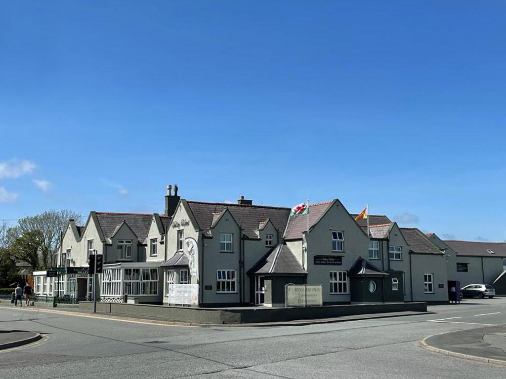 a row of houses on a city street with a road at The Valley Hotel, Anglesey in Valley