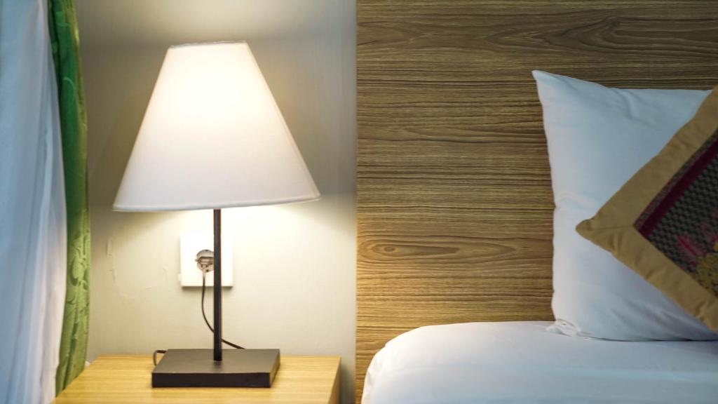 Postel nebo postele na pokoji v ubytování Pondok Pekak Guesthouse