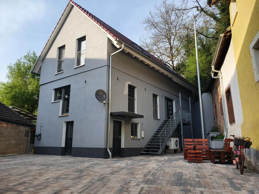 a large white building with a staircase in front of it at Haus Ziegenblick in Herbolzheim