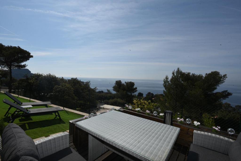 uma varanda com um banco e vista para o oceano em Mobil Home Vue sur Mer - Racine 03 em Saint-Raphaël