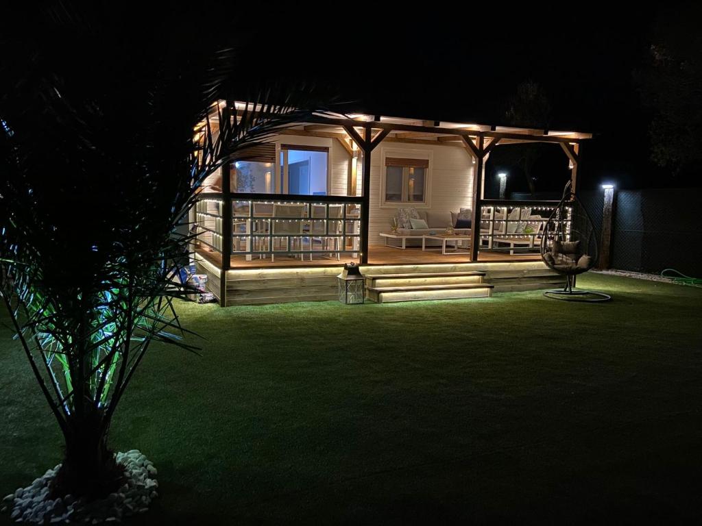 a house lit up at night with a green yard at Casa Rural La Peña in Tarifa