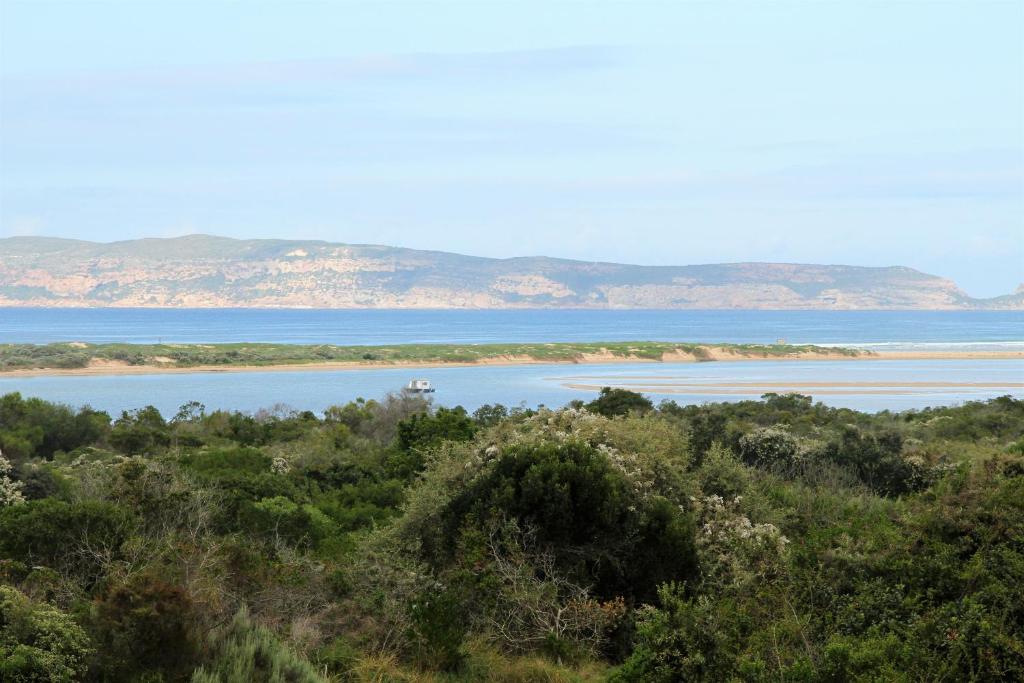 a large body of water with mountains in the background at W8 - Goose Valley Golf Estate in Plettenberg Bay