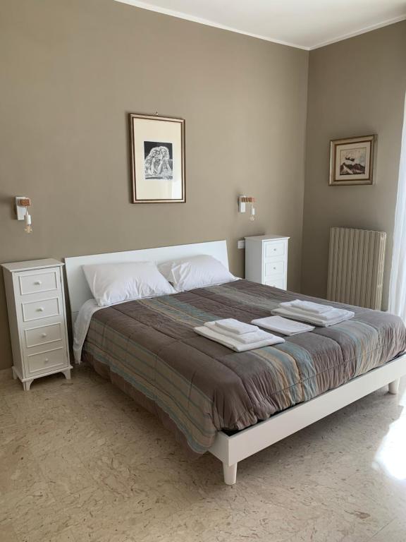 a bedroom with a large bed and a night stand at MERAVIGLIOSO in Polignano a Mare