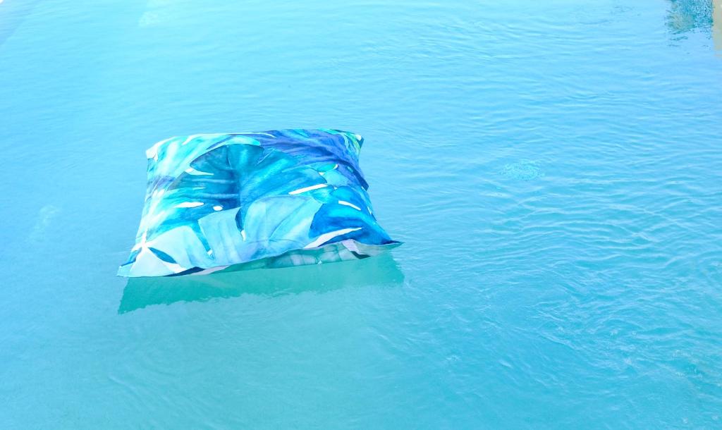 a blue object is floating in the water at Hotel Baglio Di Scopello in Scopello