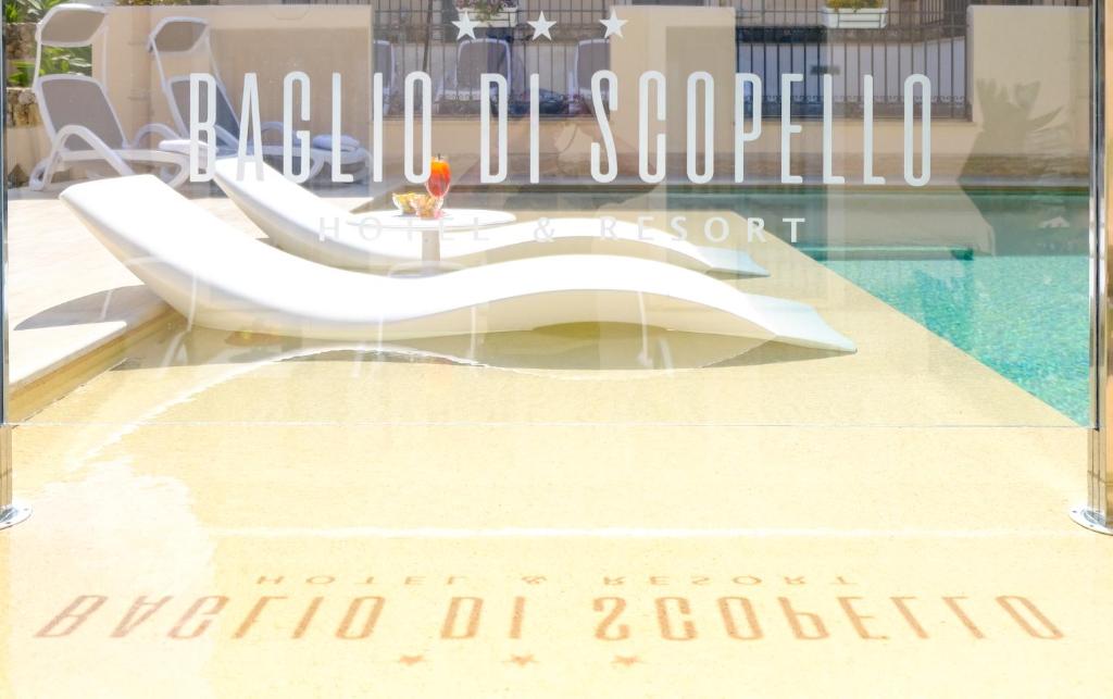 a glass window with a sign that reads melbourne school of architecture at Hotel Baglio Di Scopello in Scopello