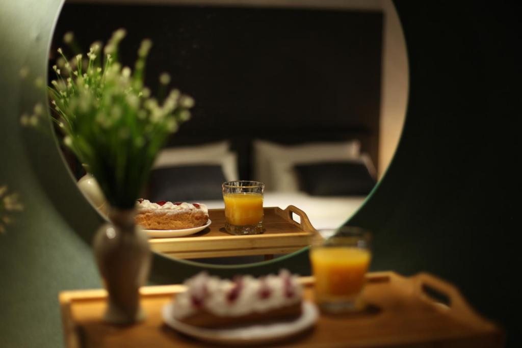 a table with two glasses of orange juice and a plate of food at Luxury Duplex Studios - City Center in Tbilisi City