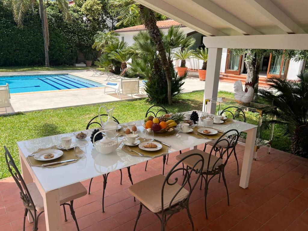 a white table with fruit on it on a patio at Domus Orestea Luxury Suites in Palermo
