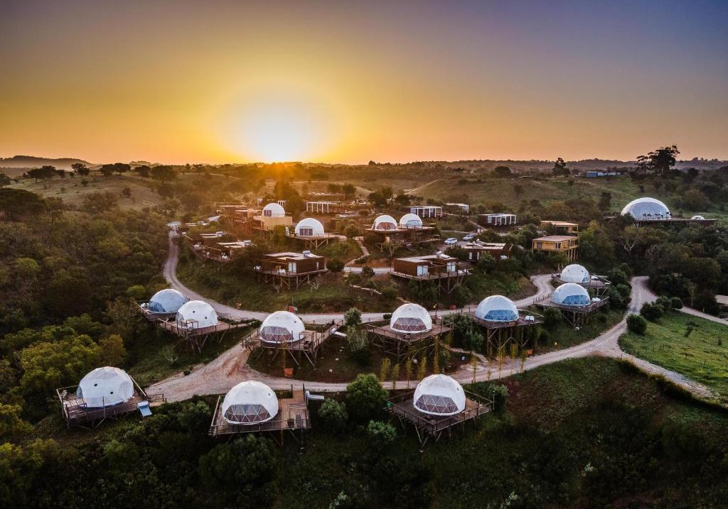 an aerial view of a resort with domes at Reserva Alecrim EcoSuite & Glamping in Santiago do Cacém