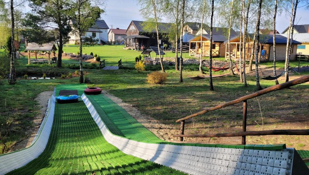 a playground with a slide in a park at Vip Village in Miedzierza