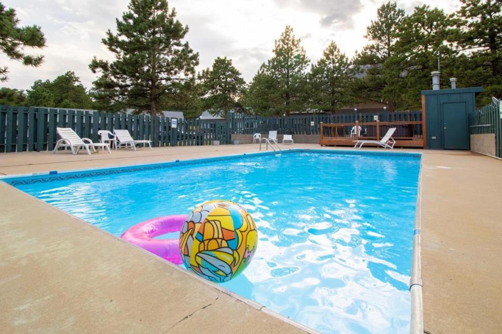 a swimming pool with a ball in the water at Saddle & Surrey Motel in Estes Park