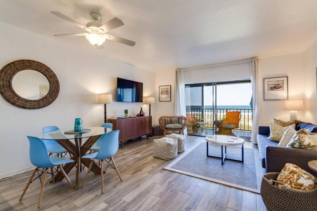 a living room with a couch and a table at Oceanfront Oasis in Jacksonville Beach
