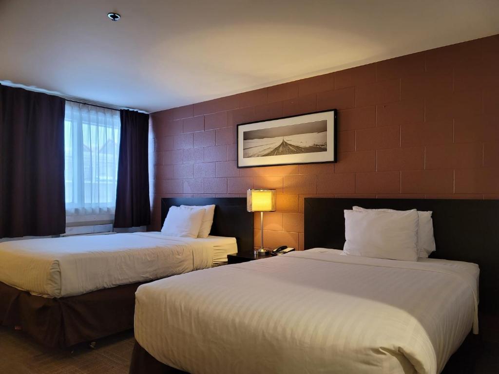 Ένα ή περισσότερα κρεβάτια σε δωμάτιο στο Roadking Inns Motel