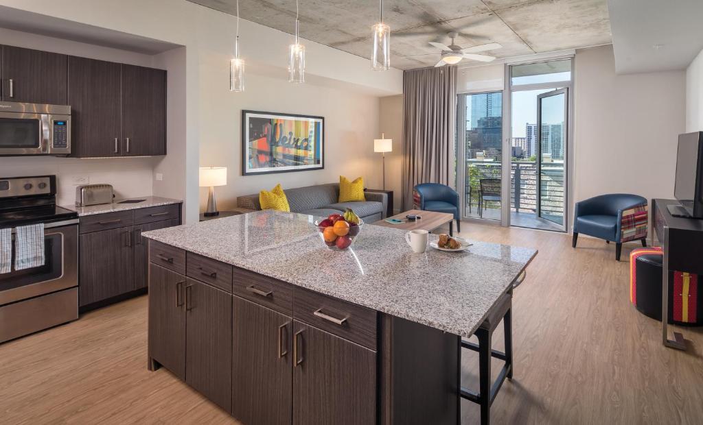 a kitchen and living room with a large island in a apartment at Club Wyndham Austin in Austin