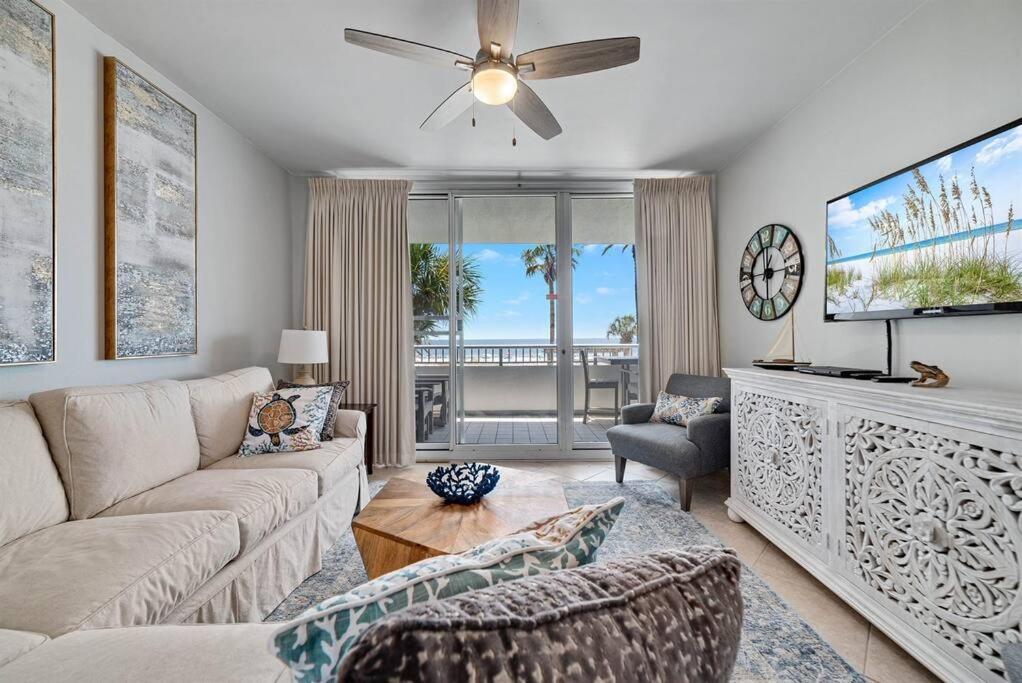 a living room with a couch and a flat screen tv at Bristol 205 - Beachfront Condo with Breathtaking Views in Gulf Shores