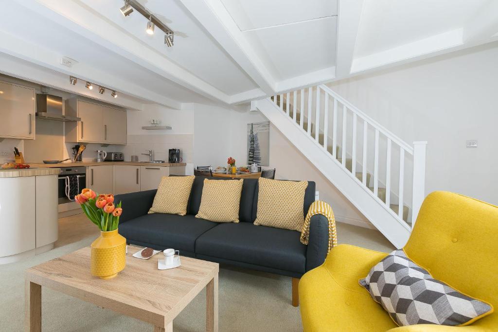 a living room with a couch and a table at White Surf Cottage in St Ives