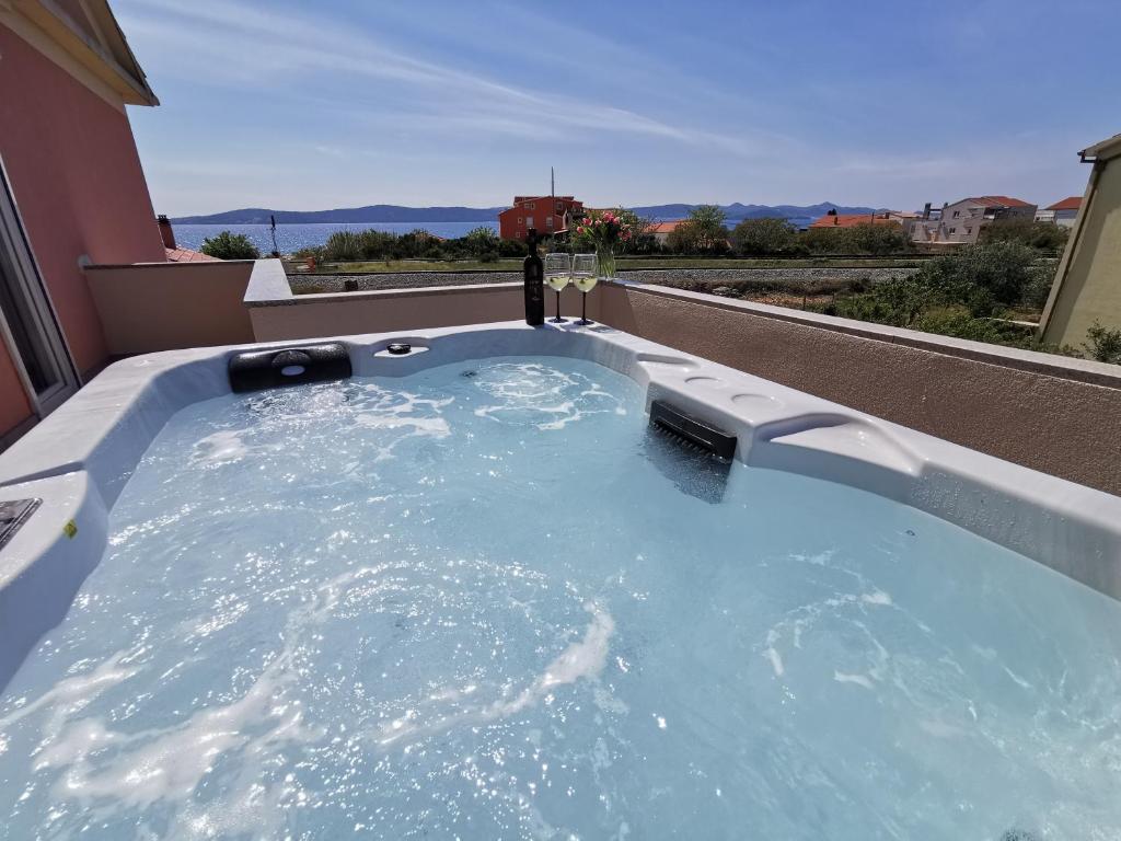 a hot tub on the roof of a house at Apartments Sorić in Bibinje