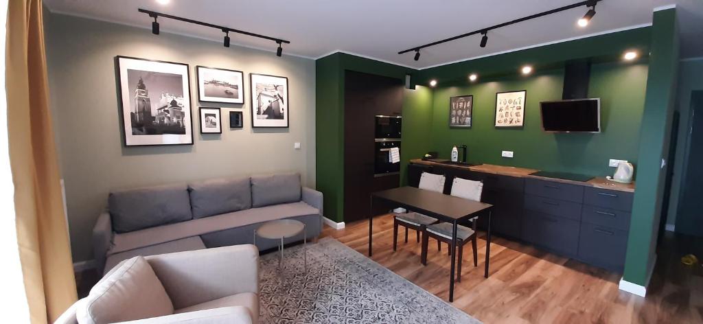 a living room with a couch and a table at Wielicka Street Apartment in Krakow