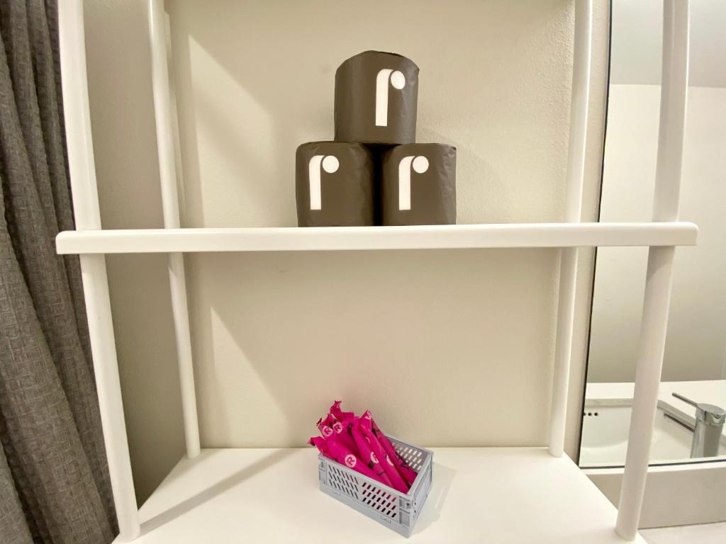 a shelf with two black bottles on it at Amorcito de Jenny - Shared House in Portland