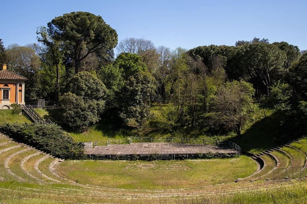 een tuin met bomen en een huis op de achtergrond bij Appartamento Mamma Sandra, incantevole tre posti più uno in Florence