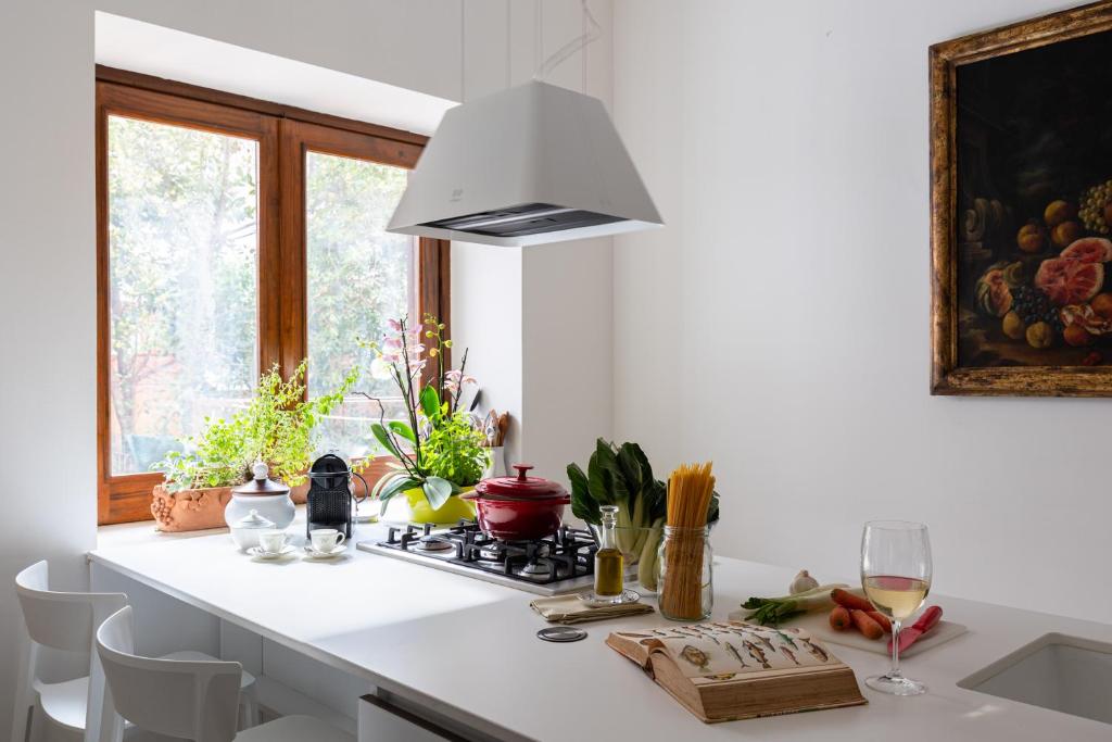 a white kitchen with a stove and a window at Domus Orestea Luxury Suites in Palermo