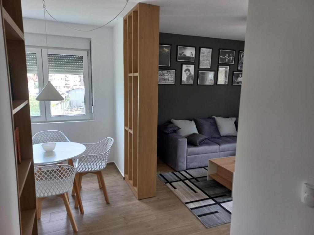 a living room with a table and a couch at Lovely one bedroom apartment in Ub