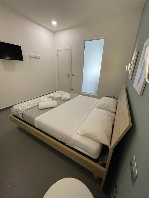 Łóżko lub łóżka w pokoju w obiekcie Le Casuzze di Siculiana