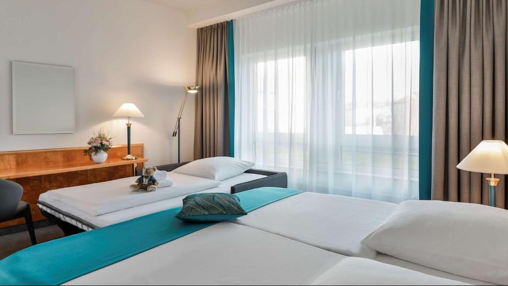 Postel nebo postele na pokoji v ubytování Dorint Hotel Dresden