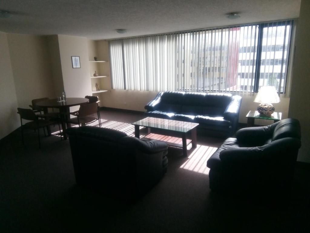 a living room with a couch and a table at Walther Suites in Quito